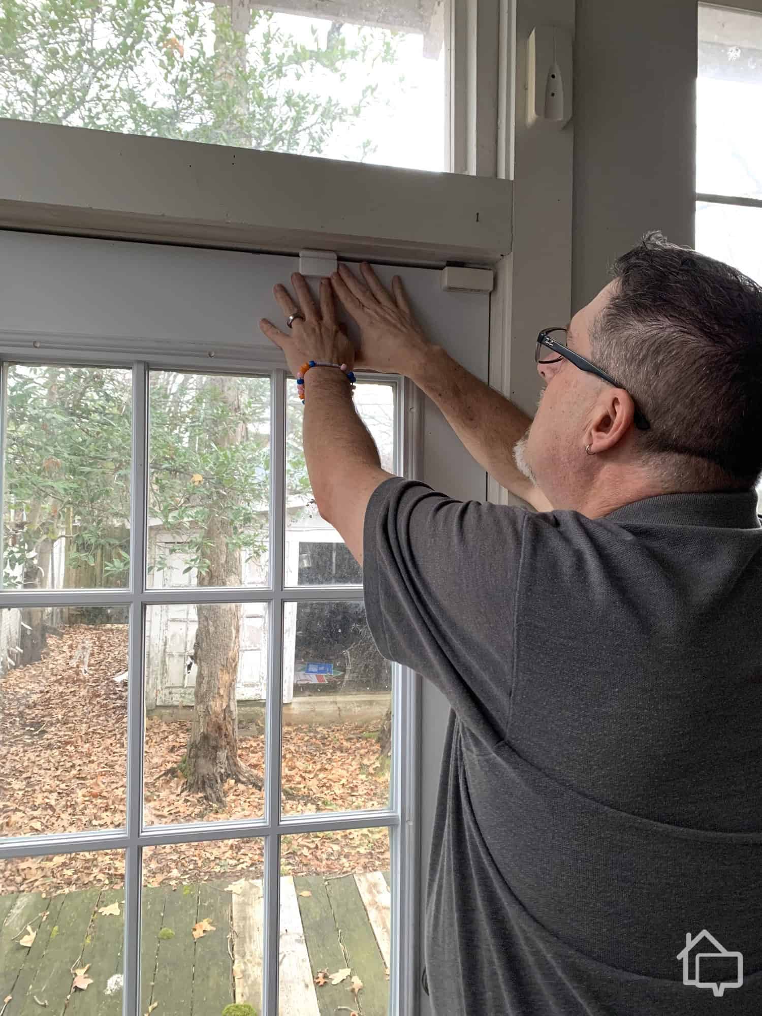 Here’s us mounting the window sensor. You can see how much smaller it is than the older window sensors we have.